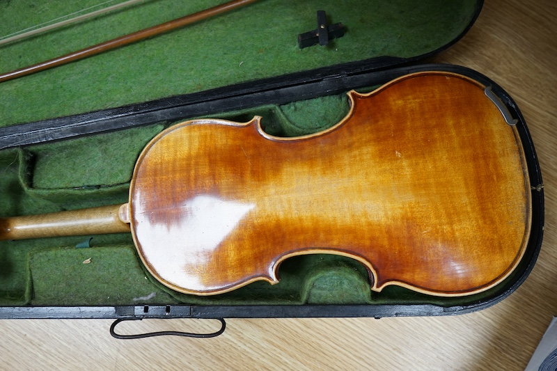 A 19th century cased violin and bow, body of violin 35.5cm long. Condition - needs restringing